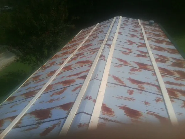Rusted metal roof panels with new wood purlins before replacement — Storm Damage Roof Repair in Pacolet Mills by Roofing Brothers