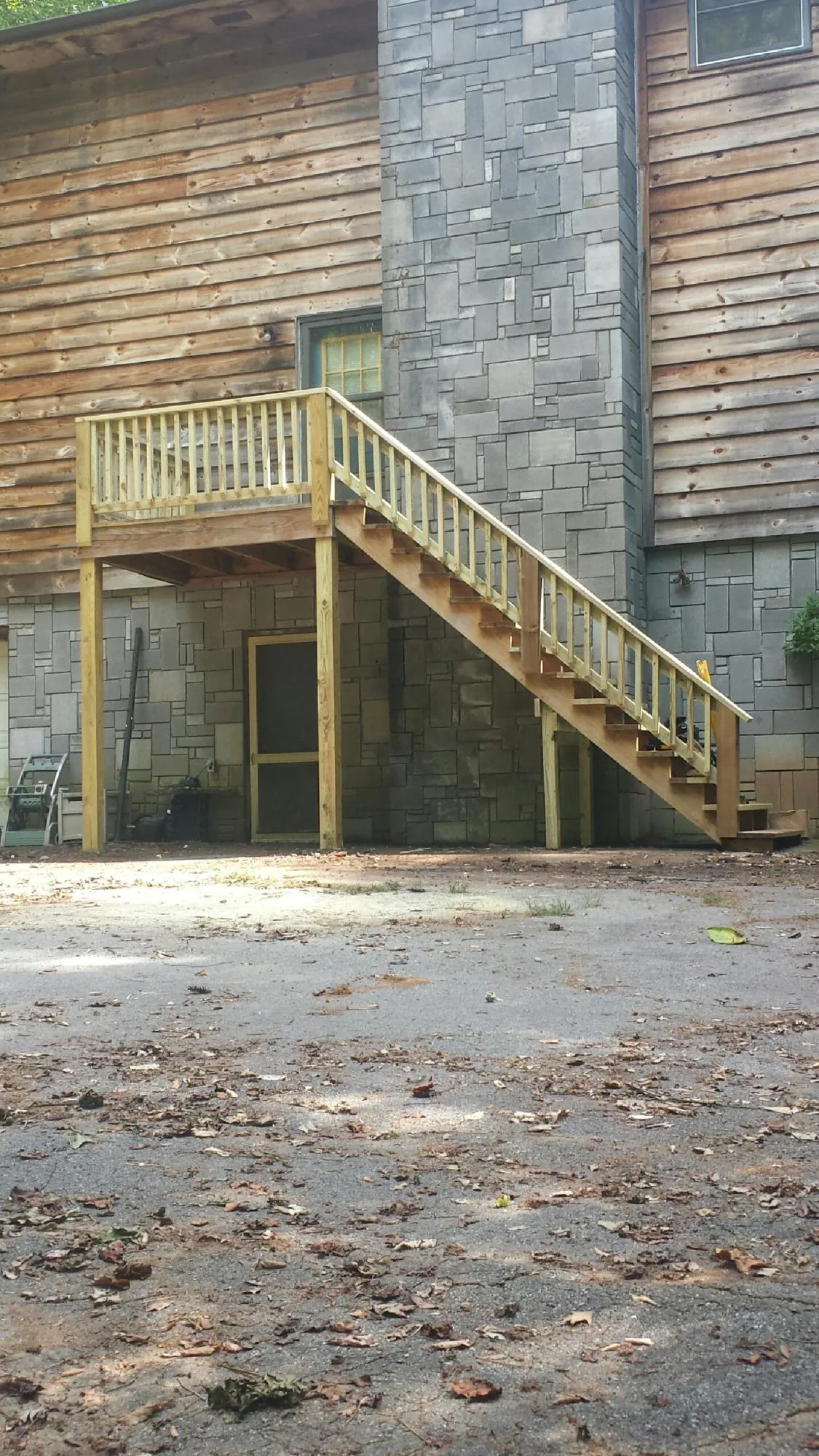 New pressure treated deck and stair landing on a log home in Pacolet Mills