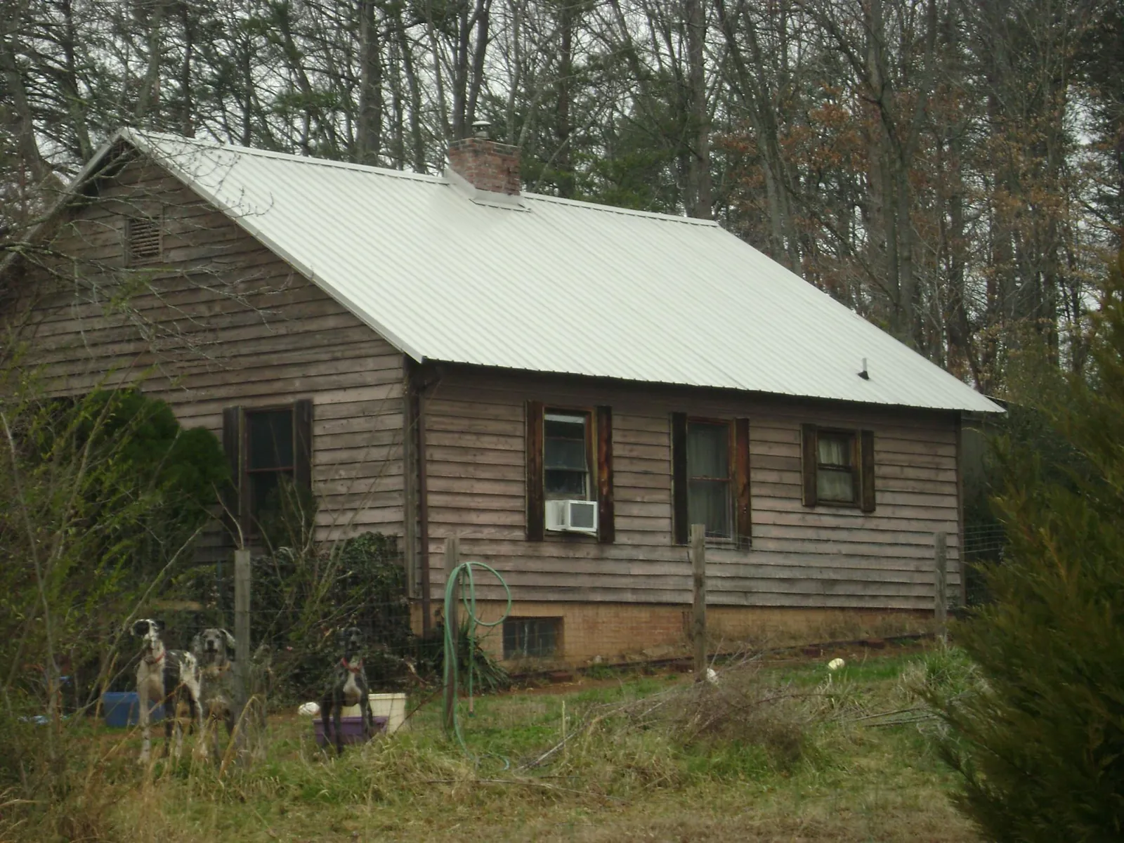 White metal roof on an old wood sided farmhouse, from a Metal Roof Installation job in Pacolet Mills